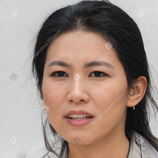 Joyful asian adult female with medium  brown hair and brown eyes