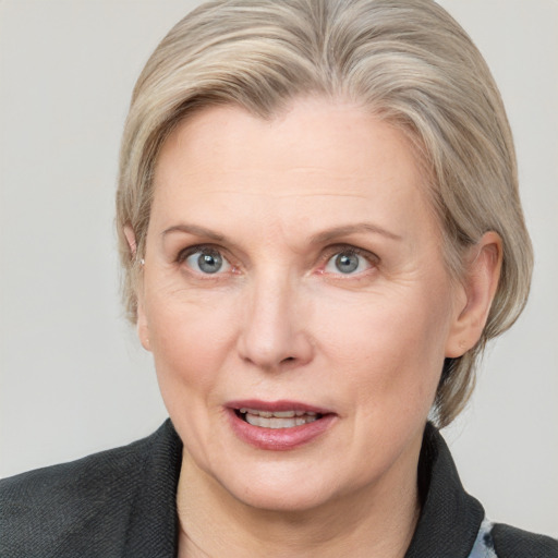 Joyful white adult female with medium  brown hair and blue eyes