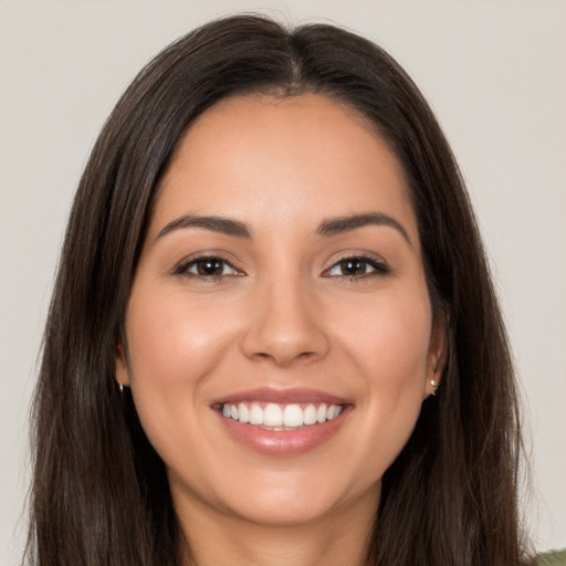 Joyful white young-adult female with long  brown hair and brown eyes