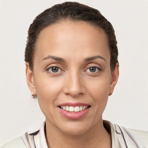 Joyful white young-adult female with short  brown hair and brown eyes