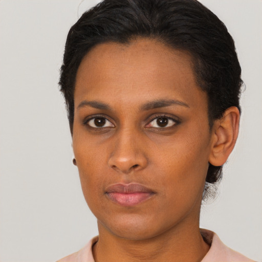 Neutral black young-adult female with short  brown hair and brown eyes