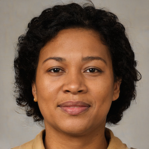 Joyful latino adult female with medium  brown hair and brown eyes