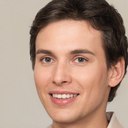 Joyful white young-adult male with medium  brown hair and brown eyes