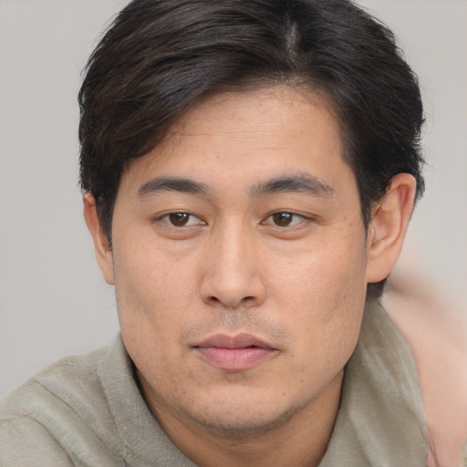 Neutral asian young-adult male with short  brown hair and brown eyes