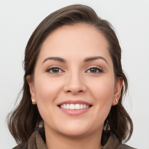 Joyful white young-adult female with medium  brown hair and grey eyes