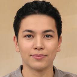 Joyful asian young-adult male with short  black hair and brown eyes