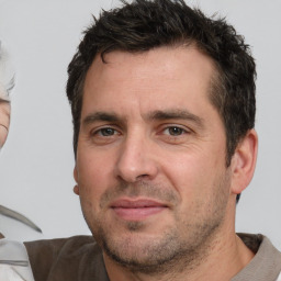 Joyful white adult male with short  brown hair and brown eyes