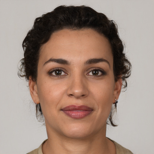 Joyful latino young-adult female with short  brown hair and brown eyes