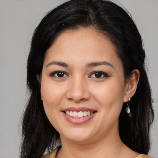 Joyful latino young-adult female with long  brown hair and brown eyes