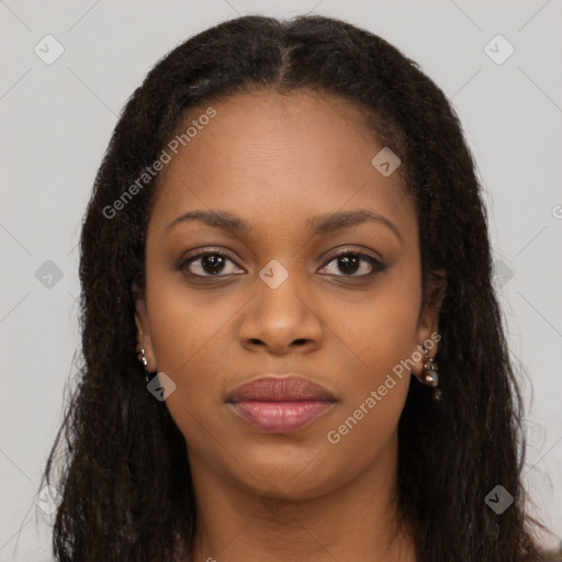 Joyful black young-adult female with long  brown hair and brown eyes