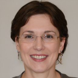 Joyful white adult female with medium  brown hair and brown eyes