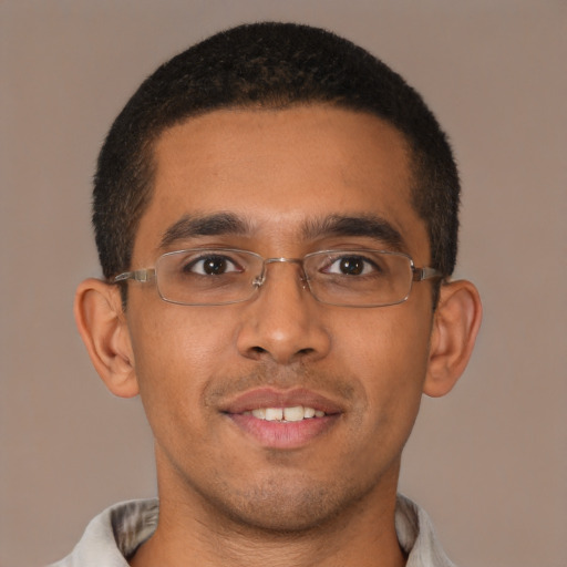 Joyful latino young-adult male with short  brown hair and brown eyes