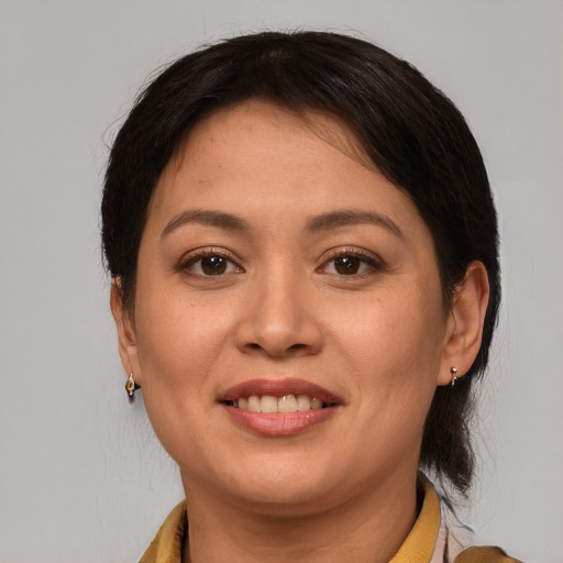 Joyful latino adult female with medium  brown hair and brown eyes