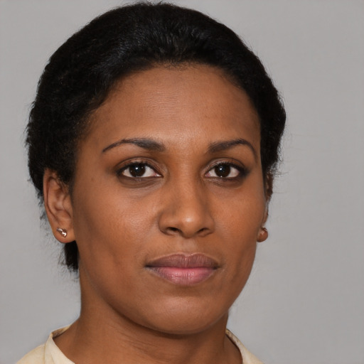 Joyful black young-adult female with short  brown hair and brown eyes