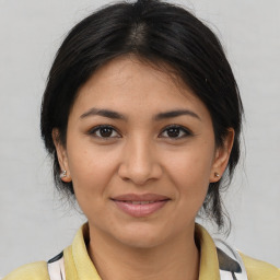 Joyful latino young-adult female with medium  brown hair and brown eyes