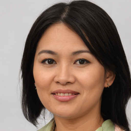 Joyful asian young-adult female with medium  brown hair and brown eyes