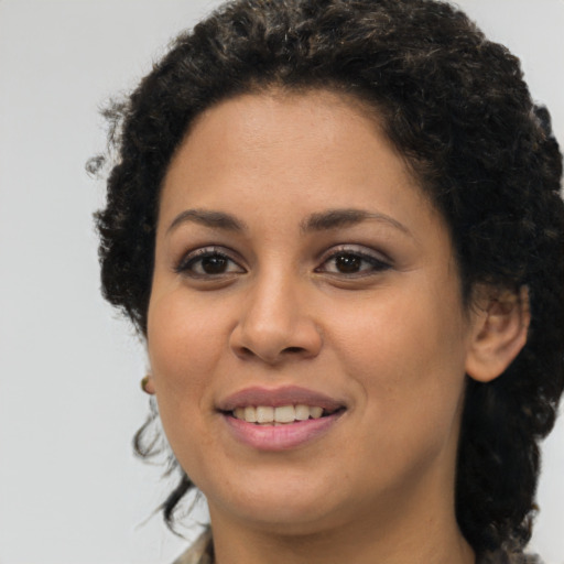 Joyful latino young-adult female with short  brown hair and brown eyes