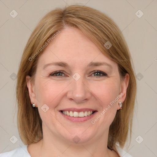 Joyful white adult female with medium  brown hair and blue eyes