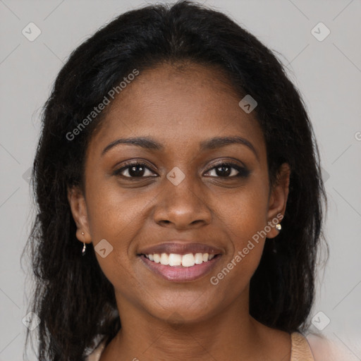 Joyful black young-adult female with long  brown hair and brown eyes