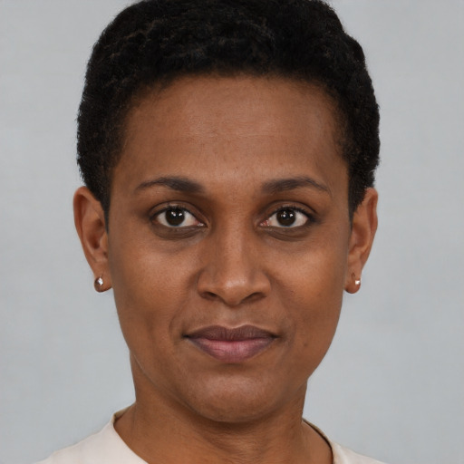 Joyful black young-adult female with short  brown hair and brown eyes