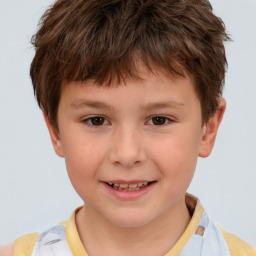 Joyful white child male with short  brown hair and brown eyes