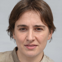 Joyful white adult female with medium  brown hair and grey eyes