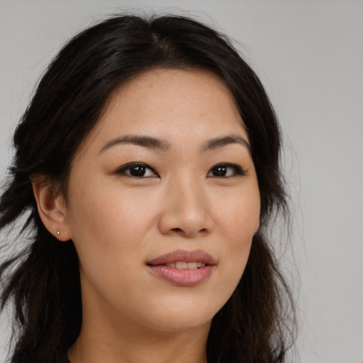Joyful asian young-adult female with long  brown hair and brown eyes