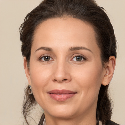 Joyful white adult female with medium  brown hair and brown eyes