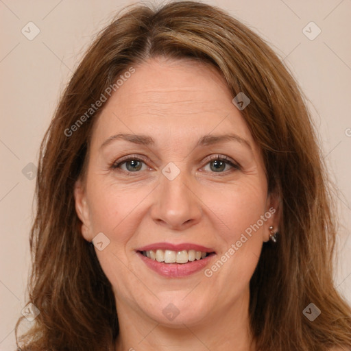 Joyful white adult female with long  brown hair and brown eyes