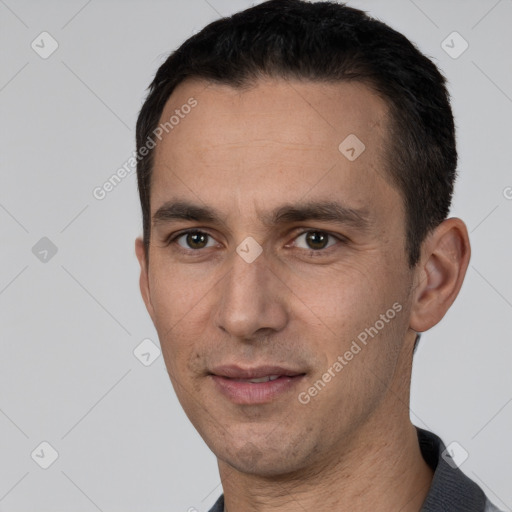 Joyful white adult male with short  black hair and brown eyes