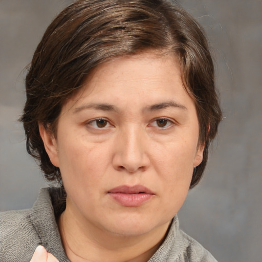 Joyful white adult female with medium  brown hair and brown eyes
