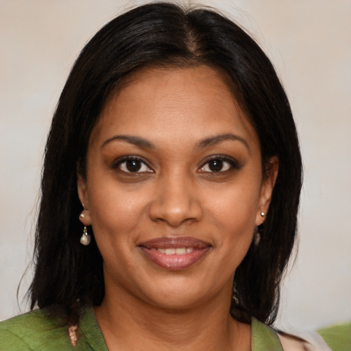 Joyful black young-adult female with medium  brown hair and brown eyes