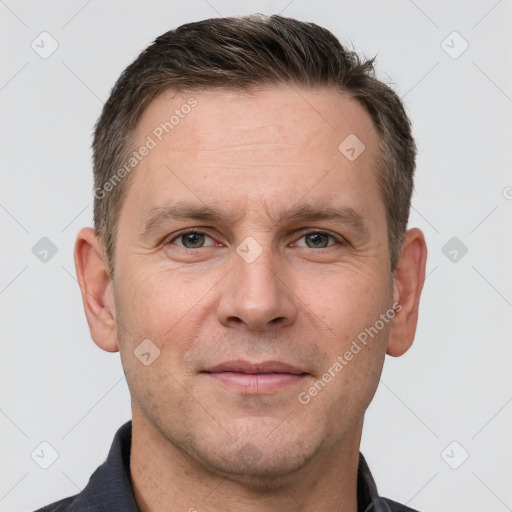 Joyful white adult male with short  brown hair and grey eyes