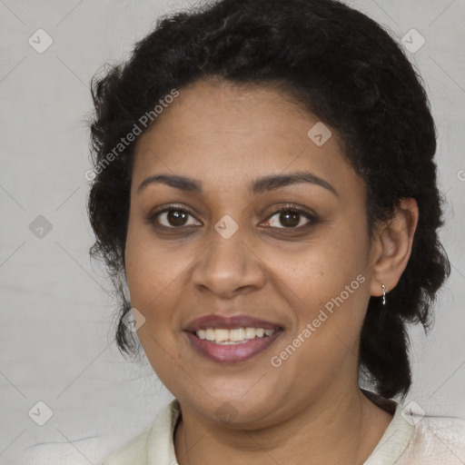 Joyful black adult female with medium  brown hair and brown eyes