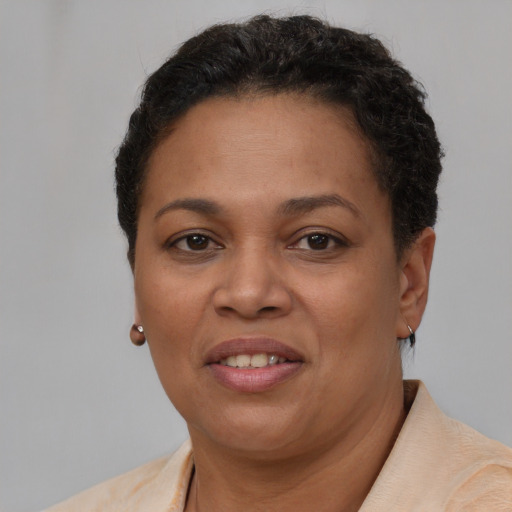 Joyful latino adult female with short  brown hair and brown eyes