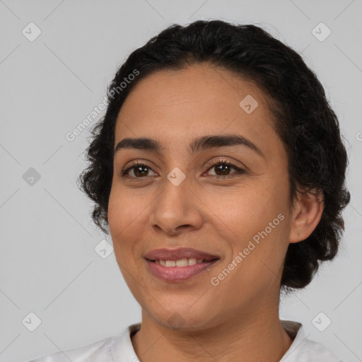 Joyful latino young-adult female with short  black hair and brown eyes