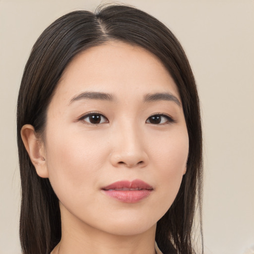 Joyful asian young-adult female with long  brown hair and brown eyes