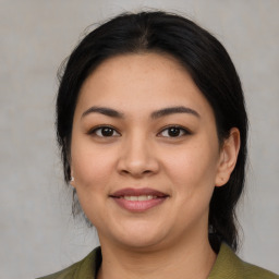 Joyful latino young-adult female with medium  black hair and brown eyes