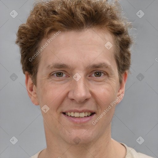 Joyful white adult male with short  brown hair and grey eyes