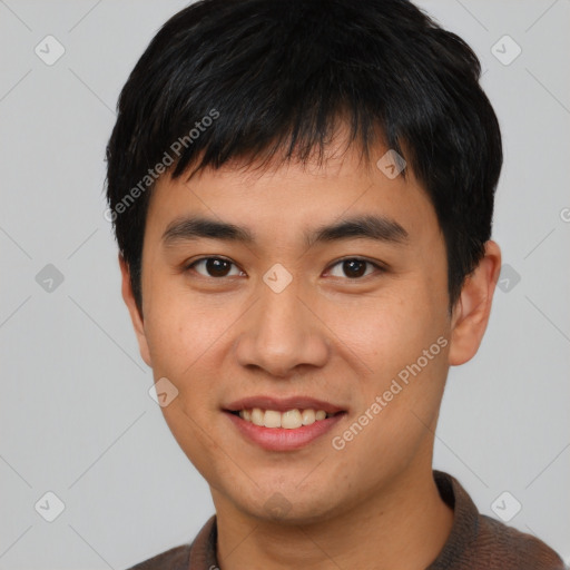 Joyful asian young-adult male with short  black hair and brown eyes