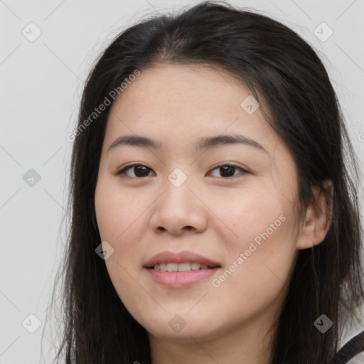 Joyful asian young-adult female with long  brown hair and brown eyes