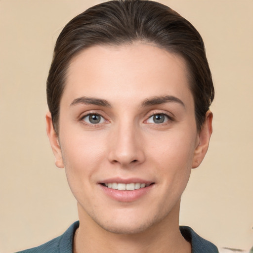 Joyful white young-adult female with short  brown hair and brown eyes