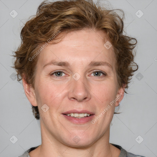 Joyful white adult female with medium  brown hair and blue eyes