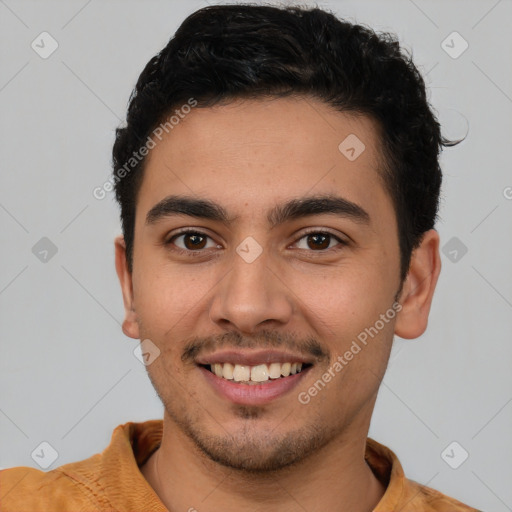 Joyful latino young-adult male with short  brown hair and brown eyes