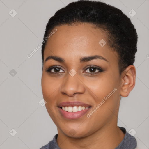 Joyful black young-adult female with short  black hair and brown eyes