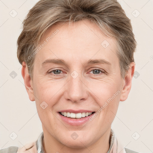 Joyful white adult female with short  brown hair and grey eyes