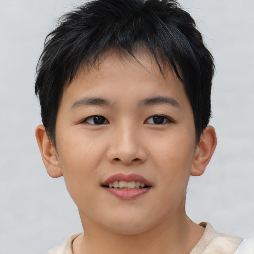 Joyful asian child male with short  brown hair and brown eyes