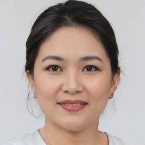 Joyful asian young-adult female with medium  brown hair and brown eyes