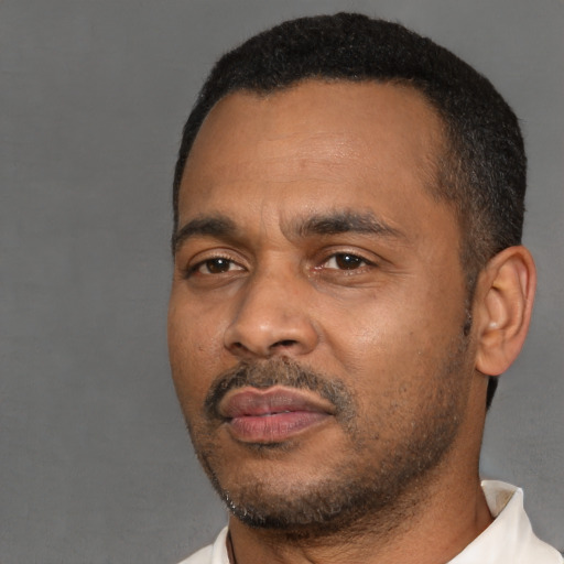 Neutral latino adult male with short  black hair and brown eyes