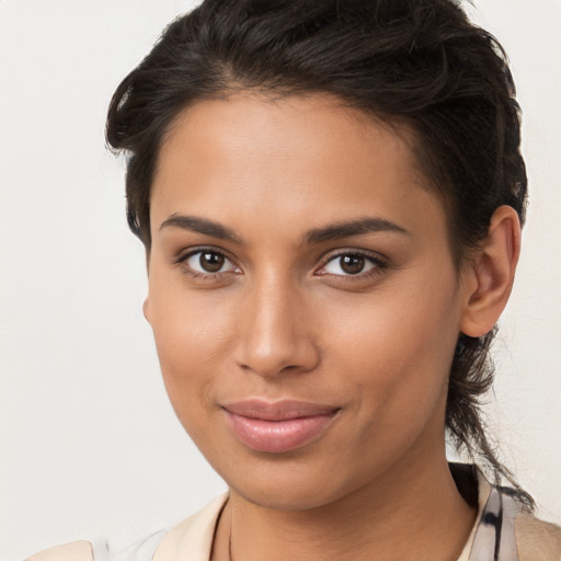 Joyful latino young-adult female with long  brown hair and brown eyes